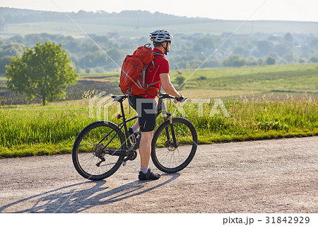 Attractive man in white helmet riding a bike on Attractive man in white helmet riding a bike on 31842929