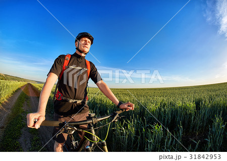 Portrait of the cyclist with mountain bike on a Portrait of the cyclist with mountain bike on a 31842953
