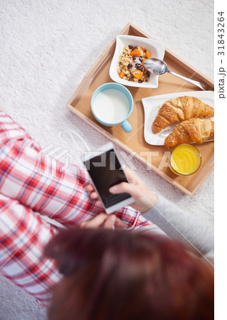 Portrait of happy woman eating breakfast in bedroom, smiling an Portrait of happy woman eating breakfast in bedroom, smiling an 31843264