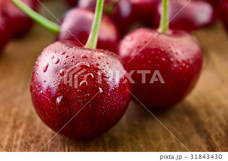 Close up of fresh cherry berries with water drops. 31843430