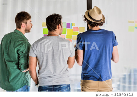 Confident young men discussing information on 31845312