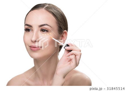 Happy beautiful girl applying visage cosmetic Happy beautiful girl applying visage cosmetic 31845514