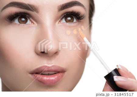 Attractive girl covering her face with decorative 31845517