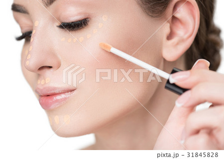Attractive young lady using make-up brush 31845828