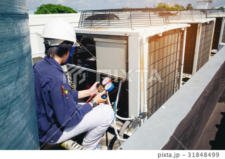 Technician is checking air conditioner Technician is checking air conditioner 31848499