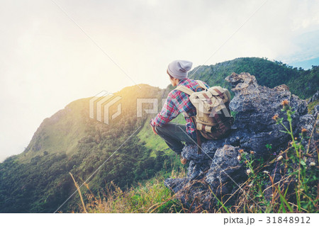 man sitting on mountain,adventure travel concept 31848912