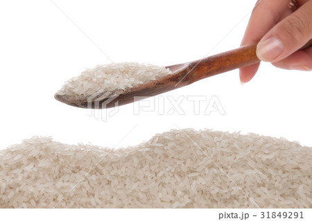 Rice in a spoon on a white background Rice in a spoon on a white background 31849291