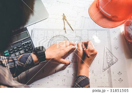 Architect or engineer working in office blueprint 31851505