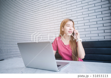 Asian girl working at a coffee shop sitting 31853113