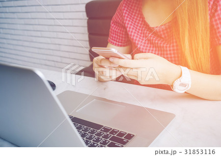 Asian girl working at a coffee shop sitting 31853116