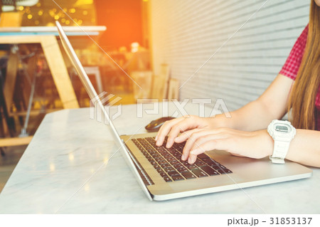Asian girl working at a coffee shop sitting 31853137
