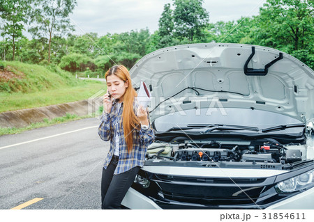 young Woman calling for assistance wit her car young Woman calling for assistance wit her car 31854611