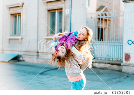 Mom and girl playing, having fun Mom and girl playing, having fun 31855202