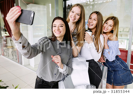 Four beautiful girls doing selfie in shopping 31855344