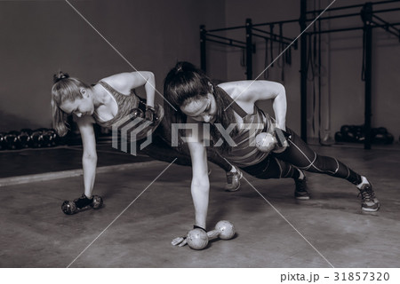 Two fit women in gym doing fitness exercises with Two fit women in gym doing fitness exercises with 31857320