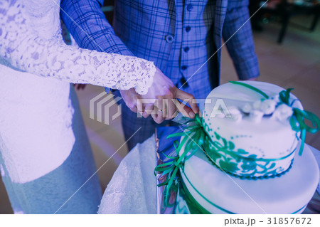 The close-up view of the newlyweds hands cutting 31857672