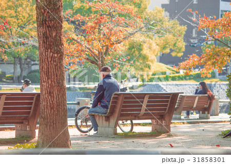 Senior adult man sit and relax on old wooden bench 31858301