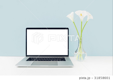 Laptop with white blank screen and flowers in vase Laptop with white blank screen and flowers in vase 31858601