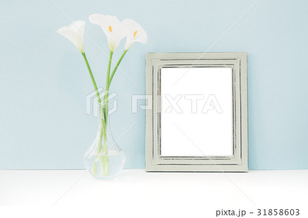 Empty wooden frame and flowers in vase on table on Empty wooden frame and flowers in vase on table on 31858603