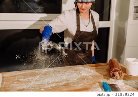 the Baker pours the flour on the table the Baker pours the flour on the table 31859224