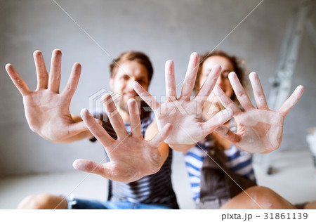 Young couple painting walls in their new house. 31861139