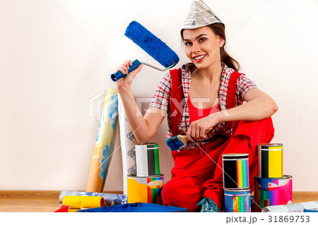 Repair home woman holding paint roller for 31869753