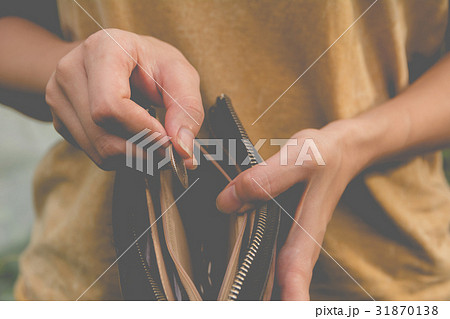Close-up woman standing and holding money coin Close-up woman standing and holding money coin 31870138