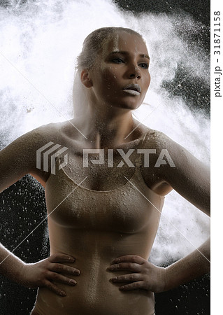 Sexy girl in white dust cloud studio portrait Sexy girl in white dust cloud studio portrait 31871158