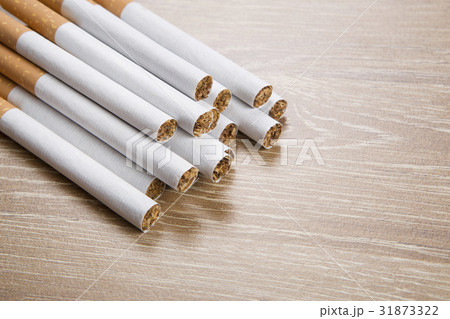 Cigarettes on brown background Cigarettes on brown background 31873322