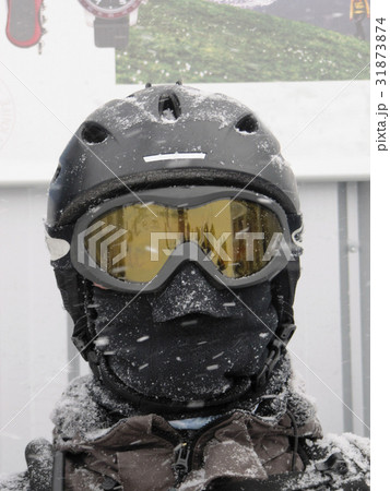 Skiier wearing a helmet and goggles 31873874