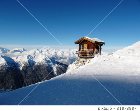 mountain hut on the side of a snow covered piste mountain hut on the side of a snow covered piste 31873987