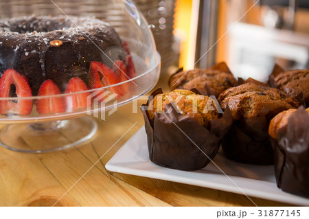 Muffins and cake on counter in coffee shop 31877145