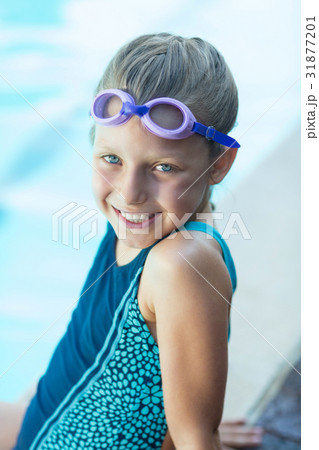 Smiling little girl sitting at poolside Smiling little girl sitting at poolside 31877201