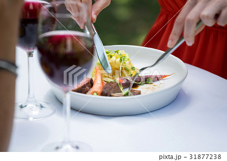 Woman having lunch at outdoor restaurant 31877238