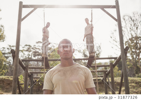 Military soldiers climbing rope during obstacle course training Military soldiers climbing rope during obstacle course training 31877326