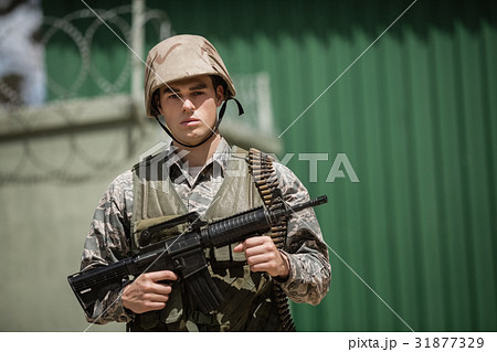 Portrait of military soldier standing with a rile Portrait of military soldier standing with a rile 31877329