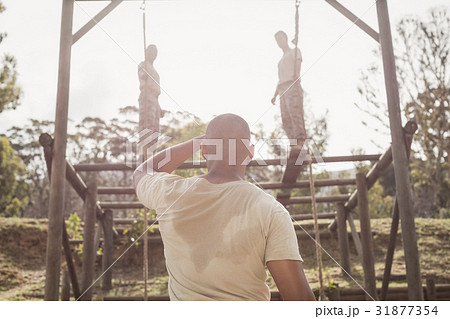 Military soldiers climbing rope during obstacle course training 31877354