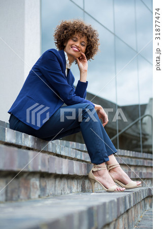 Smiling businesswoman sitting in the premises 31877474