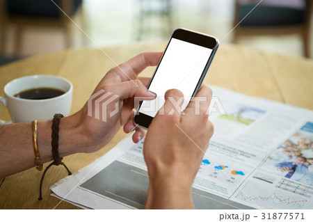 Man using mobile phone at table in coffee shop 31877571