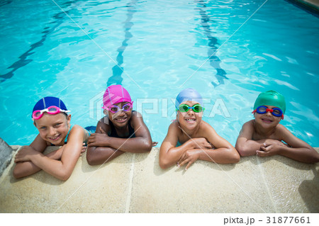 Little swimmers leaning at poolside Little swimmers leaning at poolside 31877661