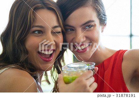Cheerful women toasting drinks in restaurant Cheerful women toasting drinks in restaurant 31878191