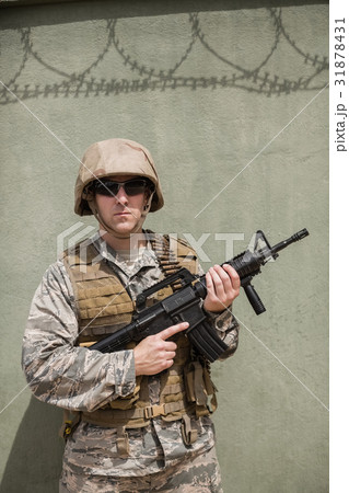 Military soldier standing with a rifle Military soldier standing with a rifle 31878431