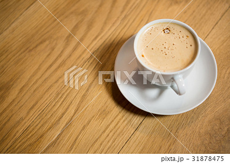 Coffee served on wooden table at cafe 31878475