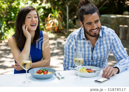 Cheerful couple having lunch at outdoor restaurant Cheerful couple having lunch at outdoor restaurant 31878517