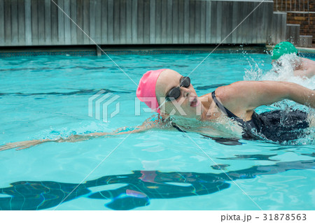 Mature woman swimming in pool 31878563