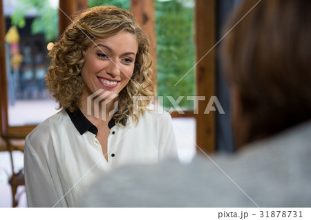 Smiling woman looking at man in coffee shop 31878731