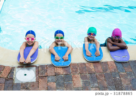 Little swimmers with kickboards at poolside 31878865