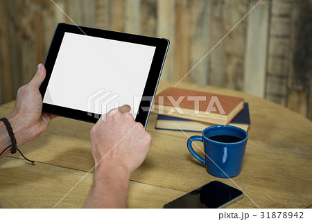 Man using digital tablet in coffee shop 31878942