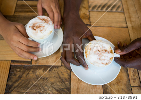 Couple hands holding coffee cups in cafe 31878991