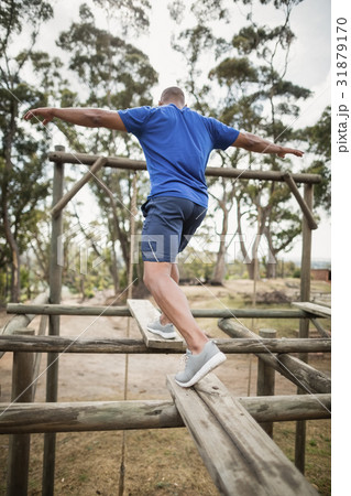Fit man during obstacle course training Fit man during obstacle course training 31879170